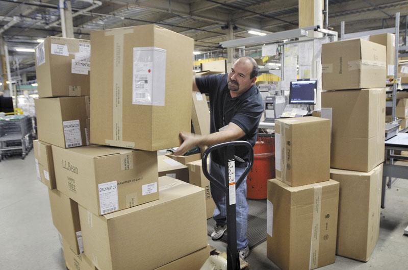 READY TO SHIP: Worker Joe Perron prepares packages to be shipped Monday at the L.L. Bean warehouse in Freeport. The company says Cyber Monday is a big day for online sales.