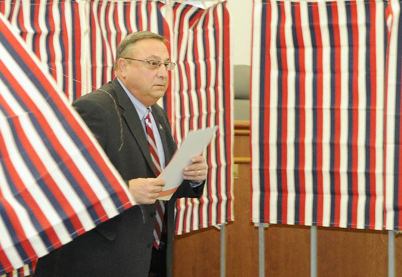 Gov. Paul LePage walks out of the polling booth this morning at Augusta City Hall. LePage, who moved to Blaine House in Augusta when he won last year's election, voted for the first time in his new city.