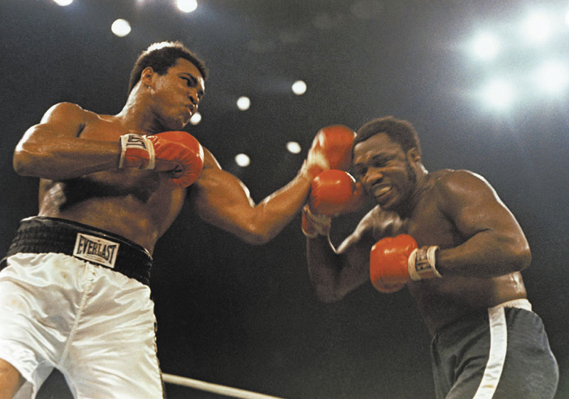 EPIC TRIOLOGY: Muhammad Ali, left, and Joe Frazier fought three times in their storied career, including this bout on Jan. 28, 1974 at Madison Square Garden. Frazier passed away Monday night at the age of 67. Boxing Heavyweight left punch l