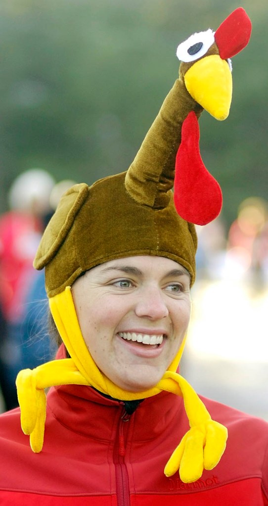 Rachel Young, of Medford, Mass. wears a turkey Thursday morning as she waits for start of the Gasping Gobbler 5K Road Race to Benefit Cony High School Athletics in Augusta.