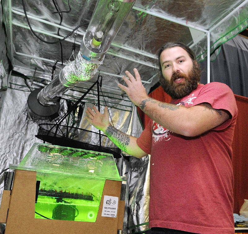 HIGH TECH MACHINE: Jake McClure, of the Medical Marijuana Caregivers of Maine, talks about indoor growing equipment in the Maine Hydroponics Supply booth during the Home Grown Maine trade show Saturday at the Augusta Civic Center.