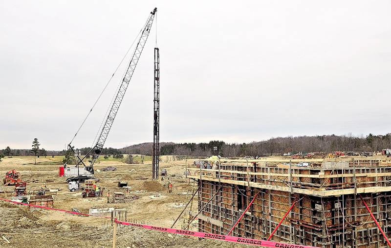 A pile driver, right and concrete forms, left, are some of the larger projects on the site on Monday afternoon as construction work continues at the site of the new MaineGeneral hospital in Augusta.