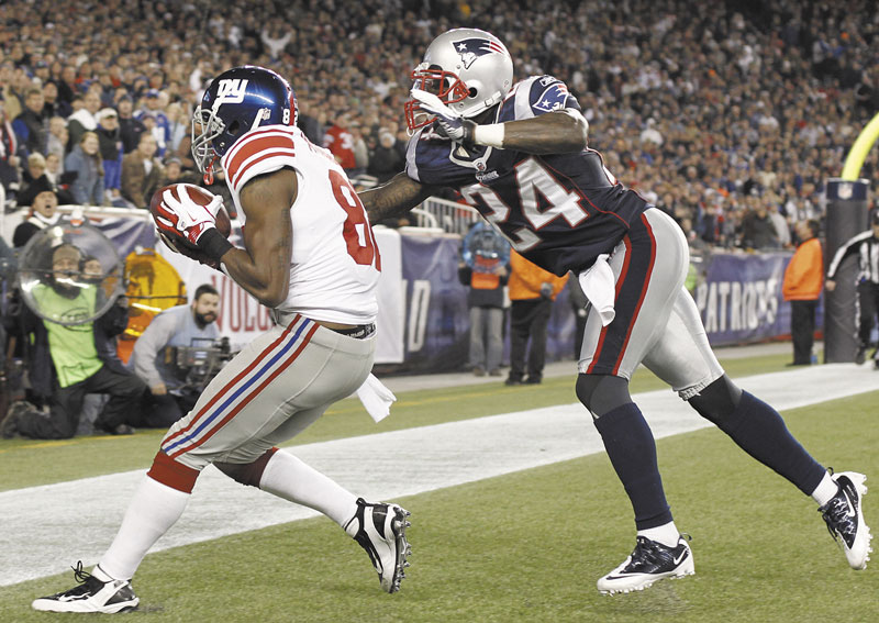 ANOTHER SCORE: New York Giants wide receiver Mario Manningham (82) catches the game-winning touchdown pass next to New England Patriots defensive back Kyle Arrington (24) in the fourth quarter last Sunday in Foxborough, Mass. The Patriots are allowing the most yards per game in the NFL.