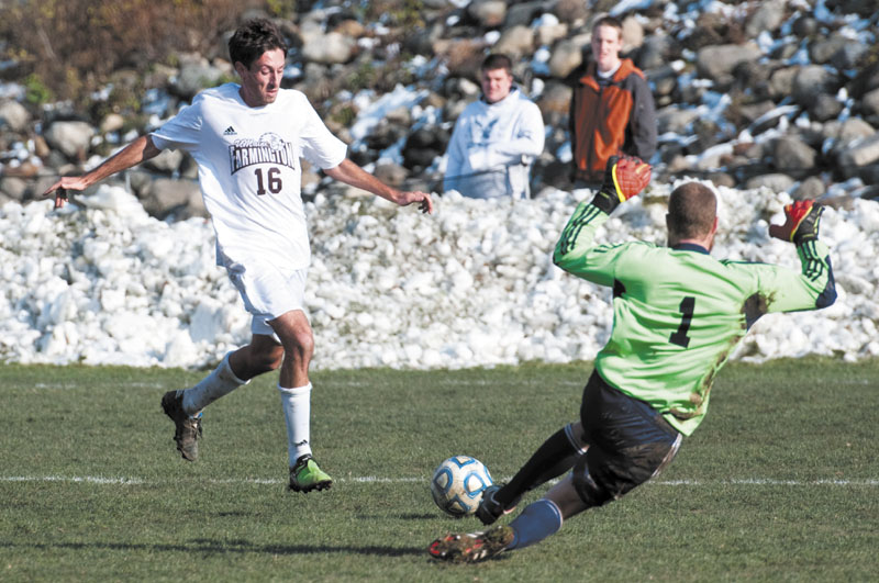 SNOW BOWL: University of Maine at Farmington midfielder and Waterville Senior High School graduate Sean Raph (16) prepares to unleash a shot as New England College goalkeeper Robert Millard comes out to make the save Monday afternoon on a snow lined Prescott Field in Farmington. Raph later assisted on Luis Ristow's goal, early in the second half as the Beavers earned a 1-0 win over the Pilgrims.