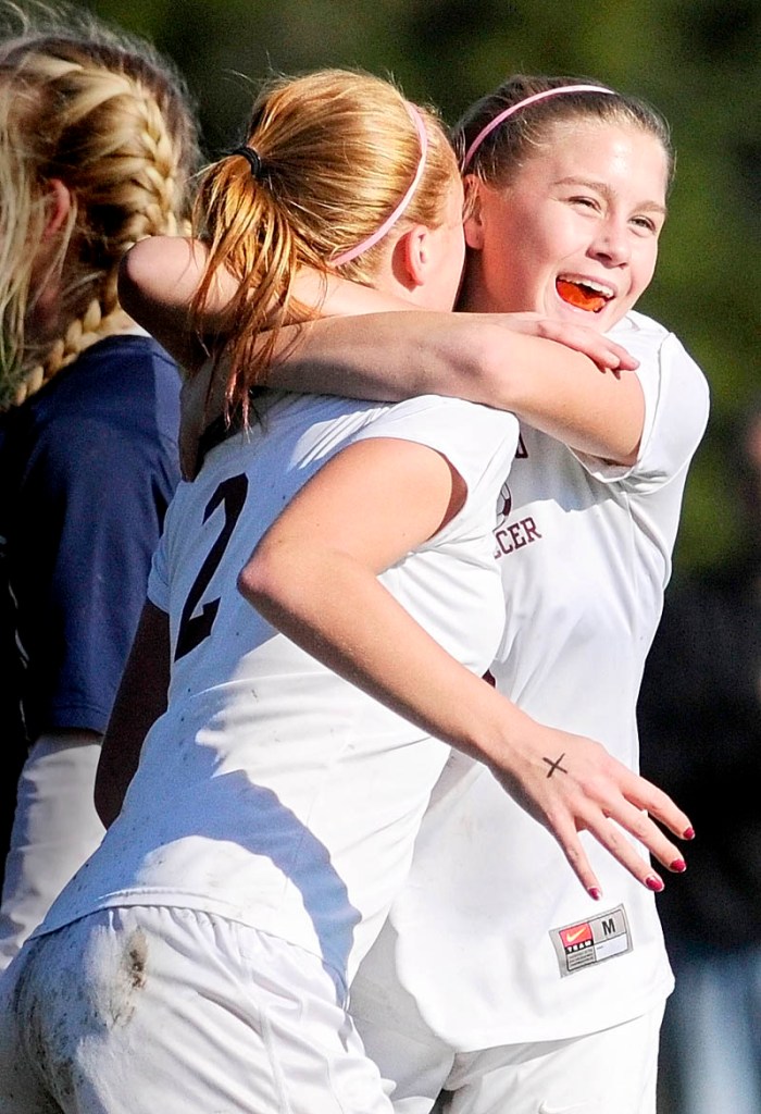 Staff photo by Joe Phelan GOOD JOB: Richmond’s Noell Acord, left, gets a hug from teammate Michaela Lewia after a goal during the Western Maine Class D championship game Wednesday in Richmond.
