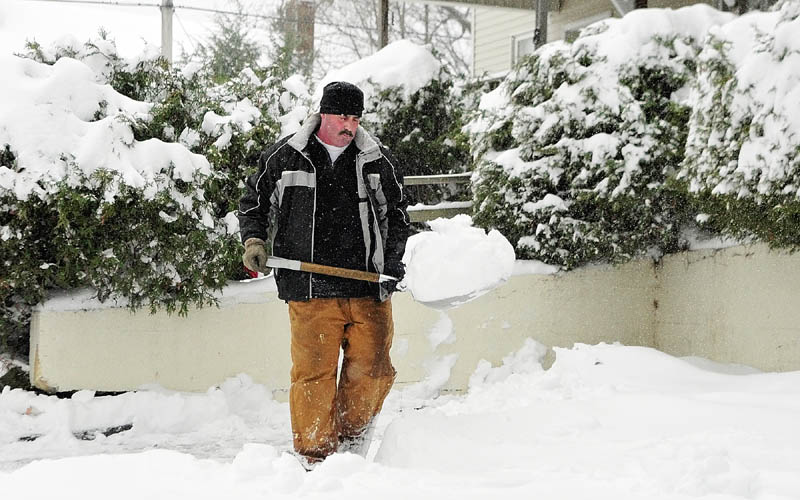 IT’S WINTER: Edward Giroux shovels snow Wednesday afternoon from an Augusta driveway. The National Weather Service in Gray said the heaviest snowfall was in Randolph. By 11 a.m., 10.8 inches fell there. Augusta received 9.3 inches.