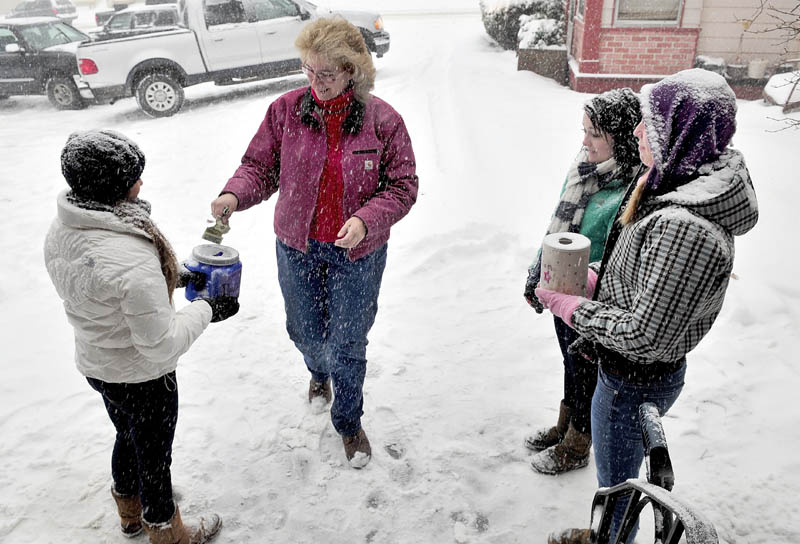 SNOW DANCE: The cold and snow on Wednesday didn't stop members of the Dance Connection dance team from seeking donations outside of Hamlin's Bakery in Fairfield. Laura Kent contributes to dancers Ali Tozier, left, Taylor Bouchard and Tricia Hasson.