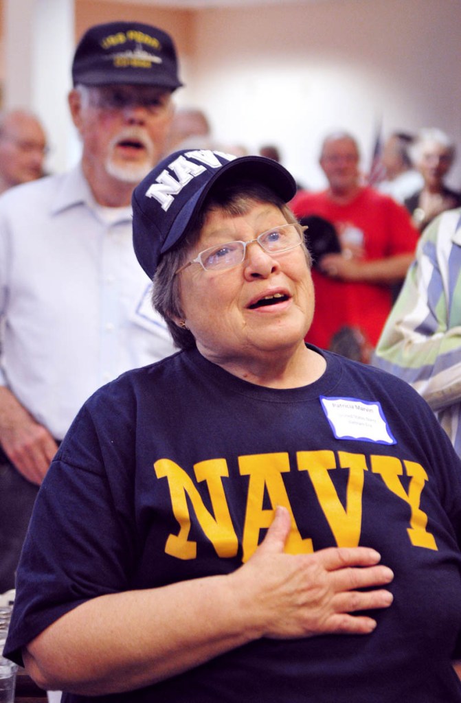 SALUTING THOSE WHO SERVED: Navy veterans Patricia Marvin, of East Winthrop, front, and Richard Duncan, of Augusta, sing the national anthem during the Veterans Day lunch Thursday at the Cohen Center in Hallowell. The center served a total of 230 lunches, 97 of them to veterans, according to center coordinator Maggie Tardiff. There were 19 World War II veterans, 29 from the Korean War and 31 from the Vietnam War, she added. The veterans’ lunch featured ham, seafood newburg, mashed potatoes, vegetables, soup, salad and dessert. It was free for veterans and cost $5 for others.