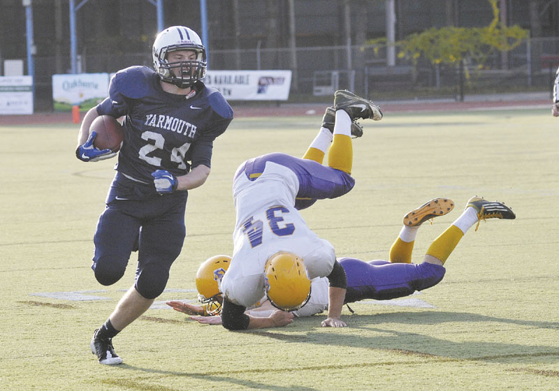 HE’S GONE: Yarmouth’s Anders Overhaug, left, makes his way to the end zone for the first time Saturday. He found the end zone five more times as Yarmouth beat Bucksport 41-14 to win its second consecutive Class C state title.
