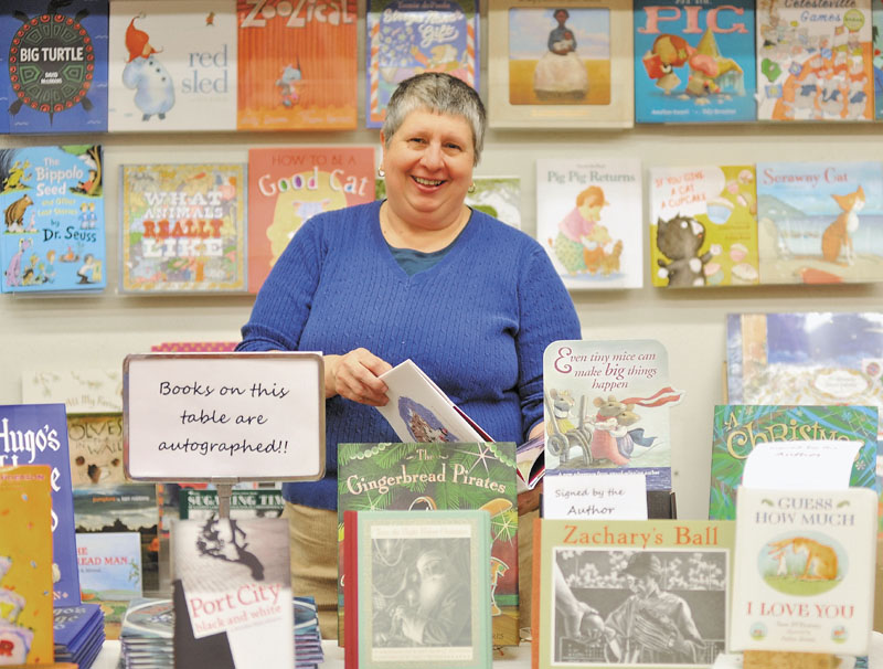 Ellen Richmond, owner of Children's Book Cellar at 52 Main St. in Waterville, organizes merchandise for holiday shoppers on Thursday.