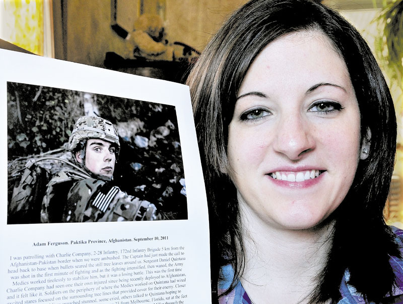 PRECIOUS PHOTO: On Tuesday Brittany Miller holds a Time magazine photograph of her husband Michael while he served in the U.S. Army in Afghanistan. The photograph was chosen for Time's Top 10 Photos of 2011.