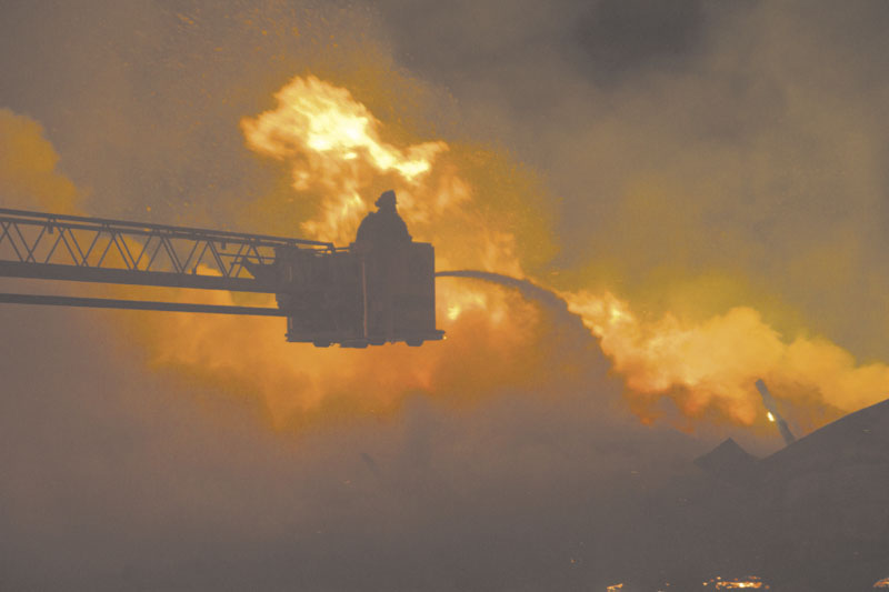 BATTLING: Flames engulf the barn at Knowlton Corner Farm in Farmington on Thursday.