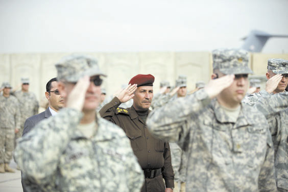 LEAVING: An Iraqi officer, center, and U.S. Army soldiers salute during ceremonies marking the end of the U.S. military mission in Baghdad on Thursday. After nearly nine years, 4,500 American dead, 32,000 wounded and more than $800 billion spent, U.S. officials formally shut down the war in Iraq a conflict that U.S. Defense Secretary Leon Panetta said was worth the price in blood and money, as it set Iraq on a path to democracy.