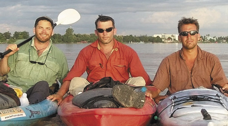 KAYAKS: Filmmakers Hutch Brown, left, and Brian Eustis, right, have strong ties to Maine. Also shown is the film's director Mick O'Shea, center. They paused for a photo on the Laos-Thailand border during their trip down the 2,800-mile Mekong River in 2004.