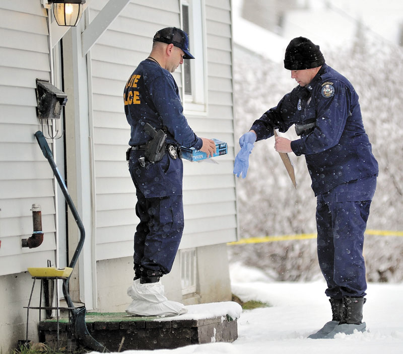 INVESTIGATION CONTINUES: Maine State Police investigators put on latex gloves and booties on Friday morning before entering the Waterville home of Ayla Reynolds, above right.