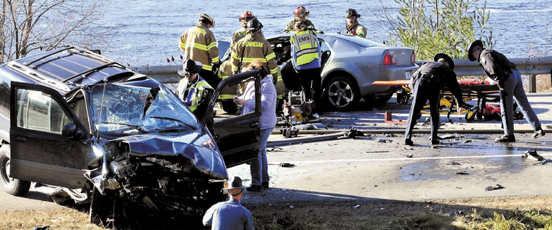 AT THE SCENE: Police and fire officials investigate the scene of a head-on collision of two cars on U.S. Route 2 in Skowhegan on Thursday. Dawn Poplawski, 59, of Canaan, was killed in the crash.