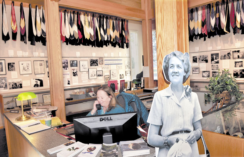 CHANGING HANDS: Margaret Chase Smith Library administrative assistant Vanessa Caron works at her desk beside a life-size image of the Senator at the library in Skowhegan on Monday. Beginning Jan. 1, the University of Maine will assume responsibility for all daily operations and programs at the library.