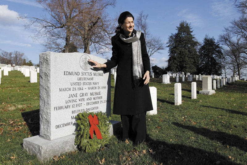 MEMORIAL: Sen. Olympia Snowe, R-Maine, places a holiday wreath on the grave of Edmund Muskie at Arlington National Cemetery in Washington on Saturday during Wreaths Across America Day. Muskie was a former Maine governor and a U.S. senator.