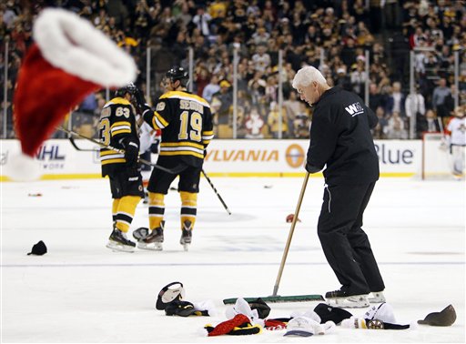 A TD Garden worker clears the ice after Boston Bruins' Brad Marchand (63) scored in the third period of a game against the Florida Panthers on Friday in Boston.