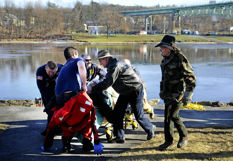 A man is pushed to an ambulance Tuesday morning after he jumped from the Calumet bridge and then was recovered from the Kennebec River in downtown Augusta. Kennebec County sheriff’s deputies, Maine State Police and Augusta police assisted the Augusta Fire Department in bringing the man to shore.