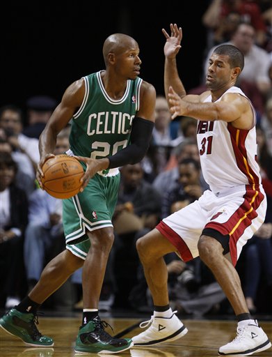 Boston Celtics guard Ray Allen, left, looks for an open teammate past Miami Heat forward Shane Battier on Tuesday in Miami.