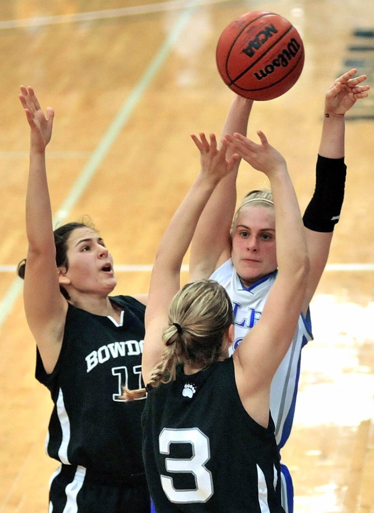 Colby College's Diana Manduca passes the ball while being defended by Bowdoin College's Jill Henrikson, left, and Amy Hackett in the second half Saturday at Wadsworth Gymnasium at Colby College.
