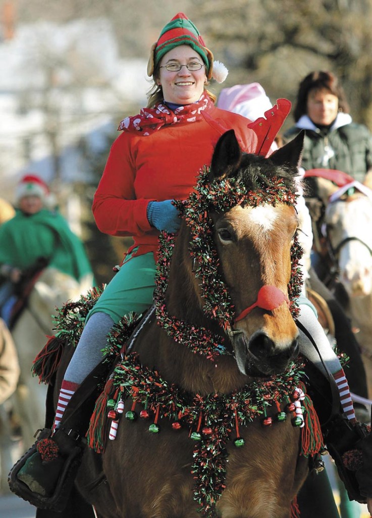 Casey Seavey of Anson rides her horse Classy up Oak Grove Road in North Vassalboro during the 2nd annual Cowboy Christmas Parade on Sunday.