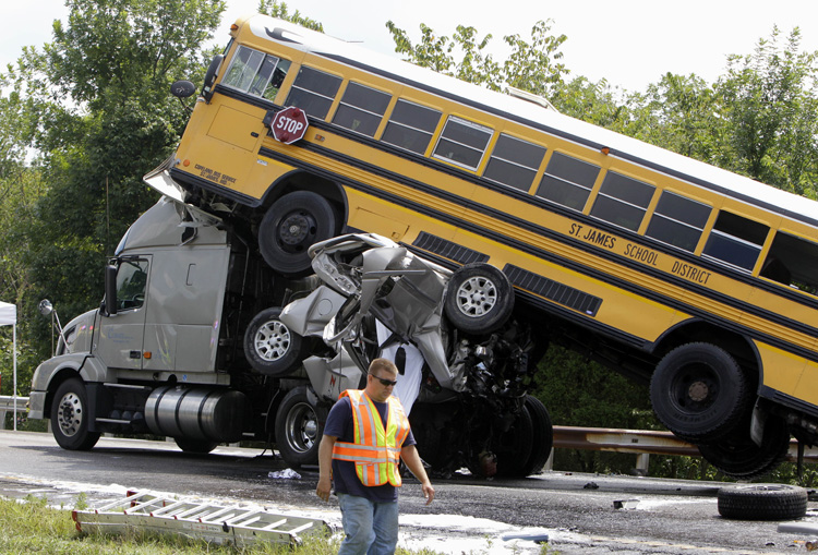 This Aug. 5, 2010, photo shows the scene of an accident involving two school buses, a tractor-trailer and another passenger vehicle, near Gray Summit, Mo. Federal safety investigators say a 19-year-old driver was texting at the time his pickup truck, two school buses and other vehicles collided in a deadly pileup on an interstate highway.