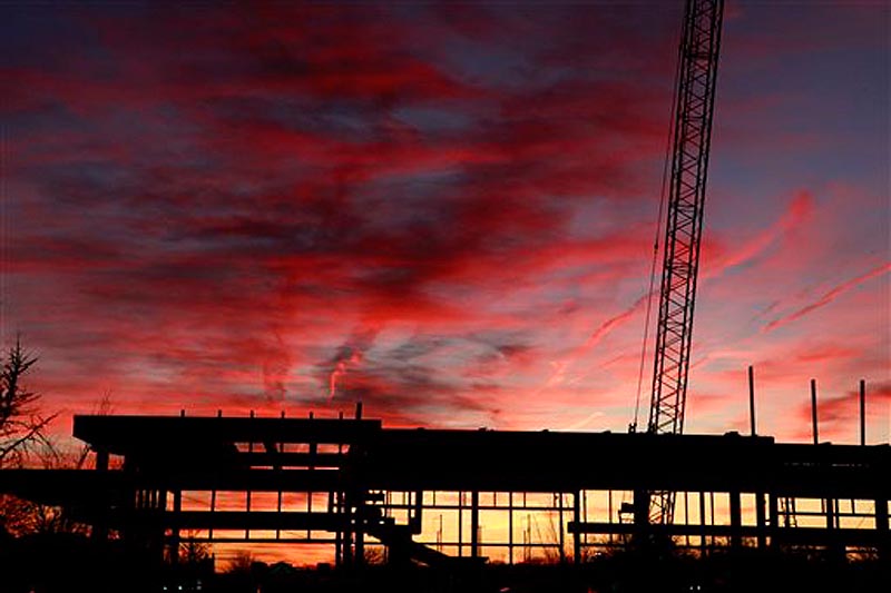 In this Nov. 25, 2011 photo, a commercial construction project is seen during sunset, at the Bala Cynwyd Shopping Center in Bala Cynwyd, Pa. The U.S. economy is ending 2011 on a roll. (AP Photo/Jacqueline Larma)