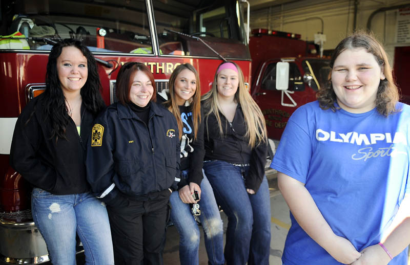 Meg Bateman, 16, right, got money and support from classmates and teachers enrolled in a firefighting class after her home burned. Student Emma Kroemer, left, instructor Marsha Graves, and students Megan Moen and Dakota Strout gave Bateman $400.00 they raised during their class at Mid-Maine Tech Center in Waterville. The group met Monday at the Winthrop Fire Department, where Bateman volunteers, before heading out on a shopping trip to replace items Bateman lost in the blaze last week.