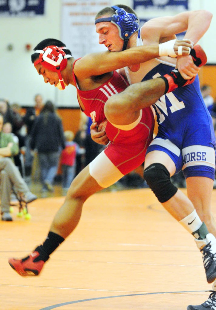TOUGH BATTLE: Cony’s Thon Itthipalakorn, left, and Morse’s Wyatt Brackett compete in the 145-pound finals at the Tiger Invitational in the John A. Bragoli Memorial Gym on Saturday at Gardiner Area High School. Brackett won a 2-1 decision.
