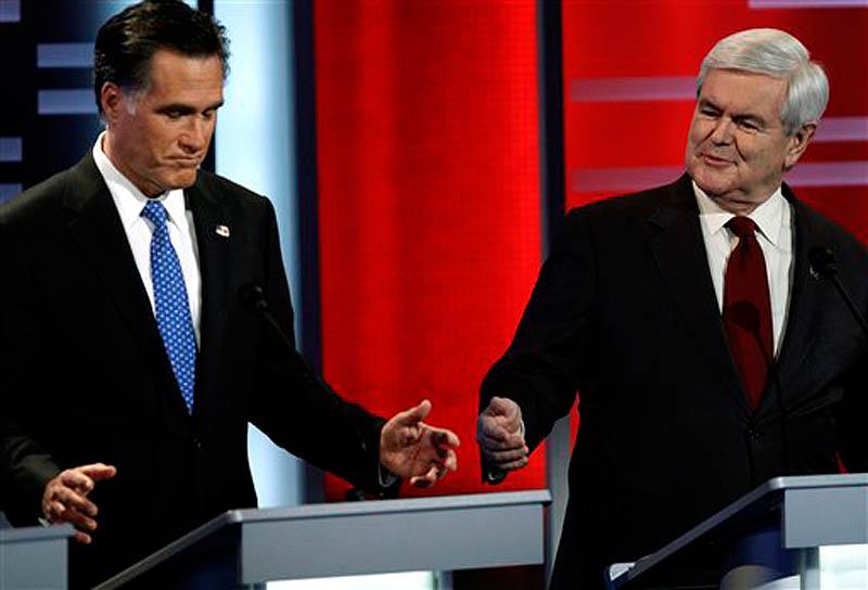Republican presidential candidates former Massachusetts Gov. Mitt Romney, left, and former Speaker of the House Newt Gingrich, right, during the Republican debate, Saturday, Dec. 10, 2011, in Des Moines, Iowa. (AP Photo/Charlie Neibergall)