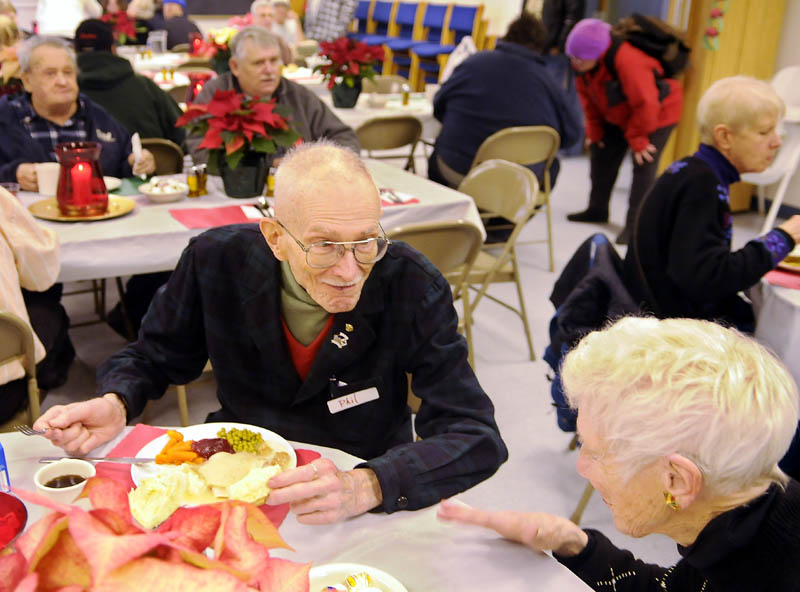 Dorothea Vogel, right, chats with Phil Tiemann Sunday while sharing a table at the community meal served at the Prince of Peace Lutheran Church in Augusta.