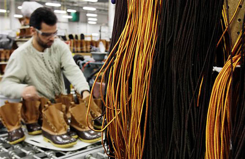 Amer Saleh of Westbrook puts laces on L.L. Bean boots in the Brunswick facility where they are assembled on Dec. 14. The popularity of L.L. Bean’s famed hunting boots has prompted the Freeport-based retailer to hire as many as 125 full-time manufacturing employees.