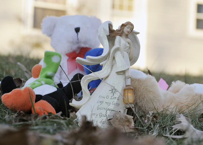 A collection of toys and mementos are placed on the lawn in front of the Waterville home where police and the FBI are investigating the disappearance of 20 month-old Ayla Reynolds.