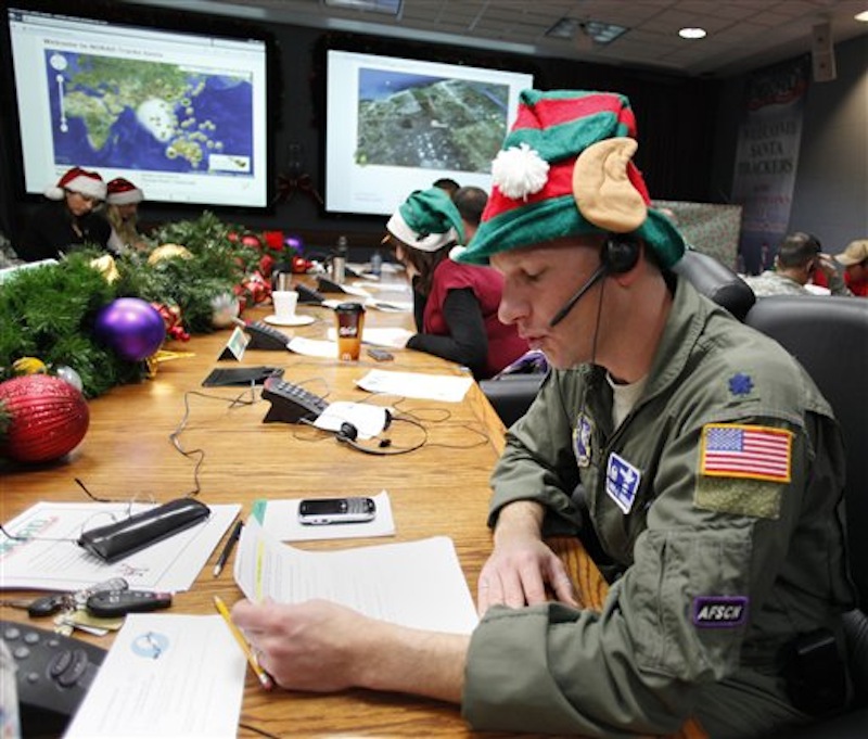 In this Dec. 24, 2010 file photo, Air Force Lt. Col. David Hanson, of Chicago, takes a phone call from a child in Florida at the Santa Tracking Operations Center at Peterson Air Force Base near Colorado Springs, Colo. (AP Photo/Ed Andrieski)