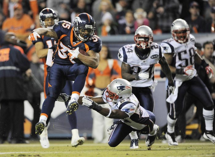 Denver Broncos running back Lance Ball (35) runs against New England Patriots defensive back Nate Jones (23) during Sunday's game in Denver.