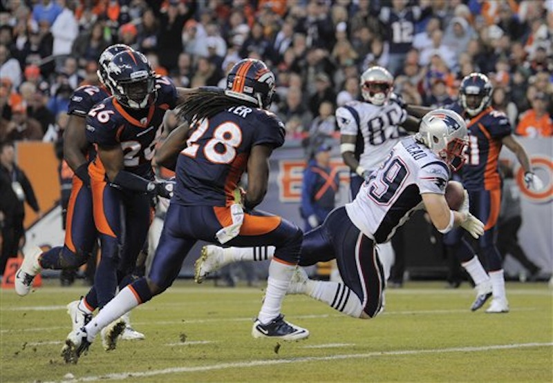 New England Patriots running back Danny Woodhead (39) crosses the goal line for a touchdown as Denver Broncos free safety Quinton Carter (28) and free safety Rahim Moore (26) defend in the third quarter of an NFL football game, Sunday, Dec. 18, 2011, in Denver. (AP Photo/Jack Dempsey) NFLACTION11;