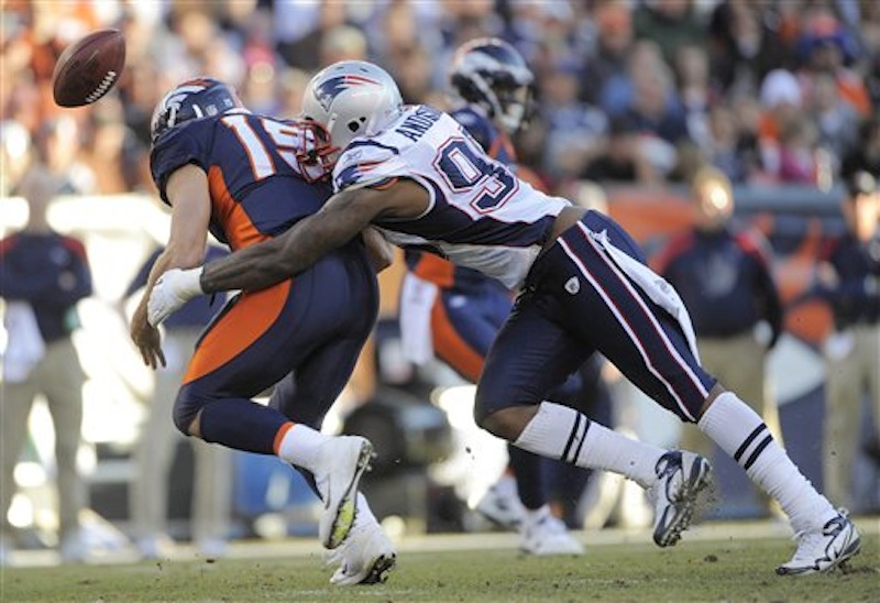 Denver Broncos quarterback Tim Tebow (15) fumbles the ball as he is hit by New England Patriots defensive end Mark Anderson (95) in the second quarter of an NFL football game, Sunday, Dec. 18, 2011, in Denver. (AP Photo/Jack Dempsey) NFLACTION11;