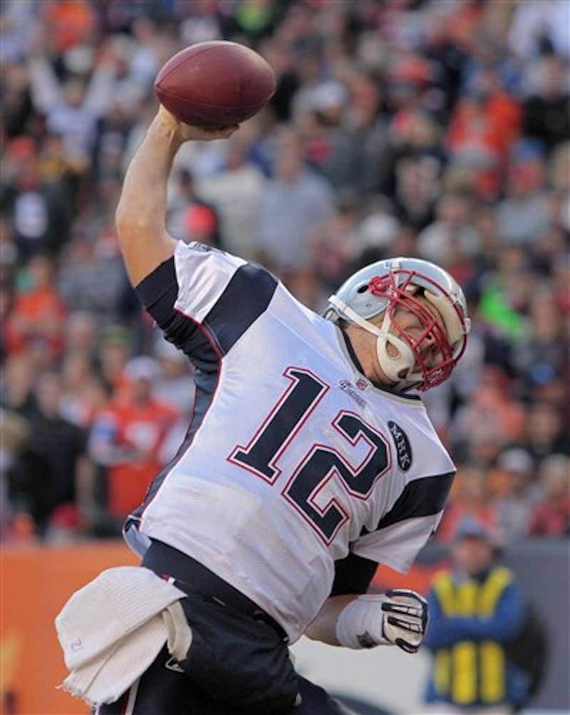 New England Patriots quarterback Tom Brady (12) reacts after scoring a touchdown against the Denver Broncos in the second quarter of an NFL football game, Sunday, Dec. 18, 2011, in Denver. (AP Photo/Barry Gutierrez) NFLACTION11