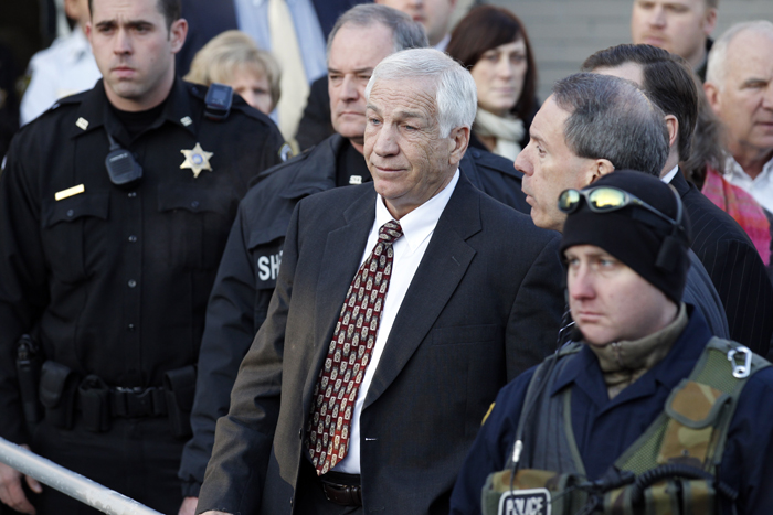 Jerry Sandusky, center, the former Penn State assistant football coach charged with sexually abusing boys, pauses as his attorney Joe Amendola, right, makes a point as they depart the Centre County Courthouse on Dec. 13, 2011, in Bellefonte, Pa.