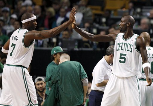 Boston Celtics' Jermaine O'Neal (7) gives a high-five to teammate Kevin Garnett as he comes off the court in the second half of the Celtics 96-85 win over the Detroit Pistons on Friday in Boston.
