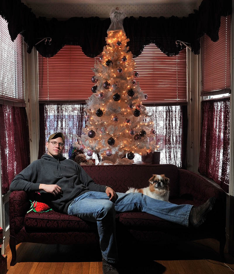 Staff photo by Michael G. Seamans Robert Fickett with his dog Binny at home in Norridgewock on Friday. Fickett served in the Army National Guard and will be home with his family for Christmas.