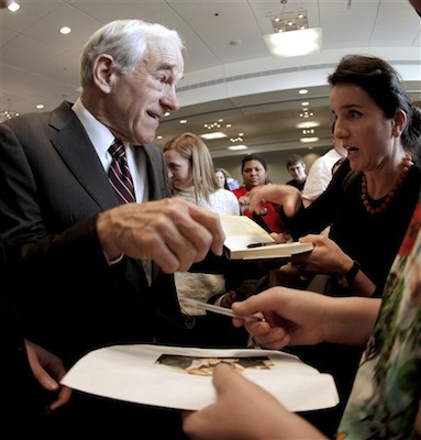 Republican presidential candidate, Rep. Ron Paul, R-Texas signs autographs during a campaign stop in Dubuque, Iowa, Thursday, Dec. 22, 2011. (AP Photo/Charlie Riedel)