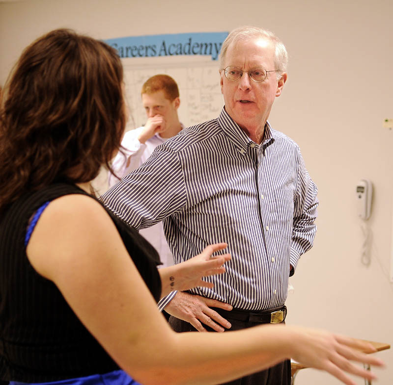 HELPING HAND: Ed Ross, from the national nonprofit organization SCORE, speaks with Capital Area Technical Center student Mariah Hazard, left, Tuesday at the Augusta school.