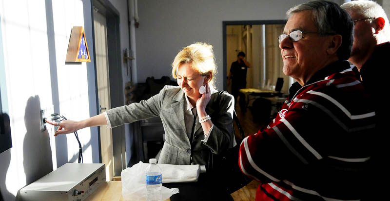 Dominique Houle presses a button Monday to fire a round in the new ballistic range at Tex Tech Industries in Monmouth. The firm, which manufactures components for body armor, held an open house at the factory.