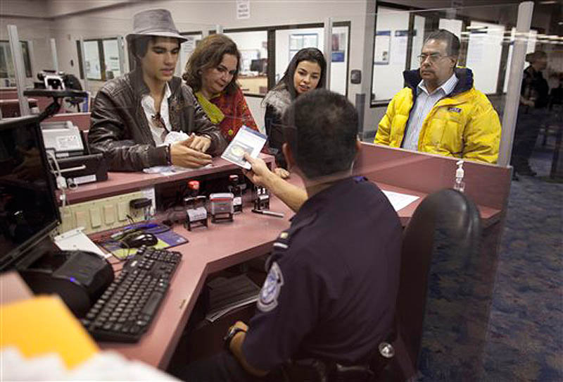 Non-resident visitors to the United States have their passports checked at immigration control after arriving at McCarran International Airport, Tuesday, Dec. 13, 2011, in Las Vegas. The U.S. Travel Association is pushing Congress to make it easier for foreigners to visit the United States. Nearly 7.6 million nonimmigrant visas were issued in 2001, compared to fewer than 6.5 million in 2010. (AP Photo/Julie Jacobson)