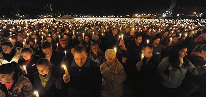 Virginia Tech students hold a candlelight vigil on the drill field, on campus, as a memorial to Virginia Tech police Officer Deriek Crouse who was gunned down Thursday during a traffic stop on the campus of Virginia Tech in Blacksburg, Va., Friday, Dec. 9, 2011. (AP Photo/Don Petersen)