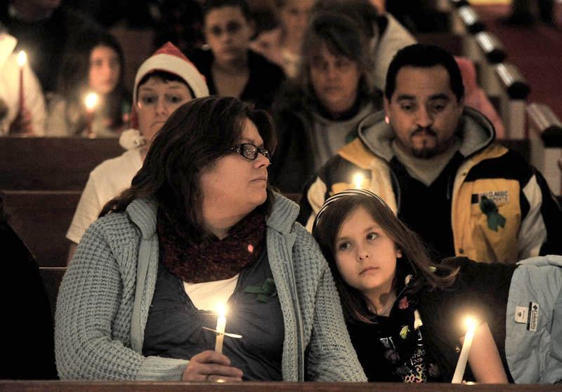 Katherine McIntyre, left, sits with her daughter Noelle, 7, during the Vigil Of Hope For Ayla Reynolds organized by The Mainely Moms & Dads Wednesday evening in the First Congregational Church.