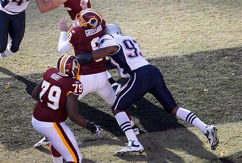 Washington Redskins quarterback Rex Grossman (8) is sacked in the end zone by New England Patriots defensive end Andre Carter during the first half of an NFL football game, Sunday, Dec., 11, 2011 in Landover, Md. (AP Photo/Pablo Martinez Monsivais)